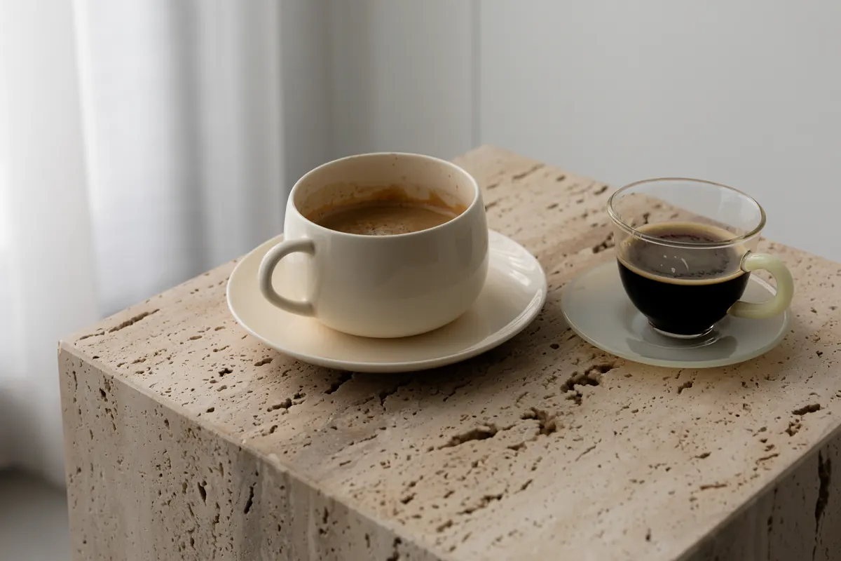 Coffee and laptop on a travertine table